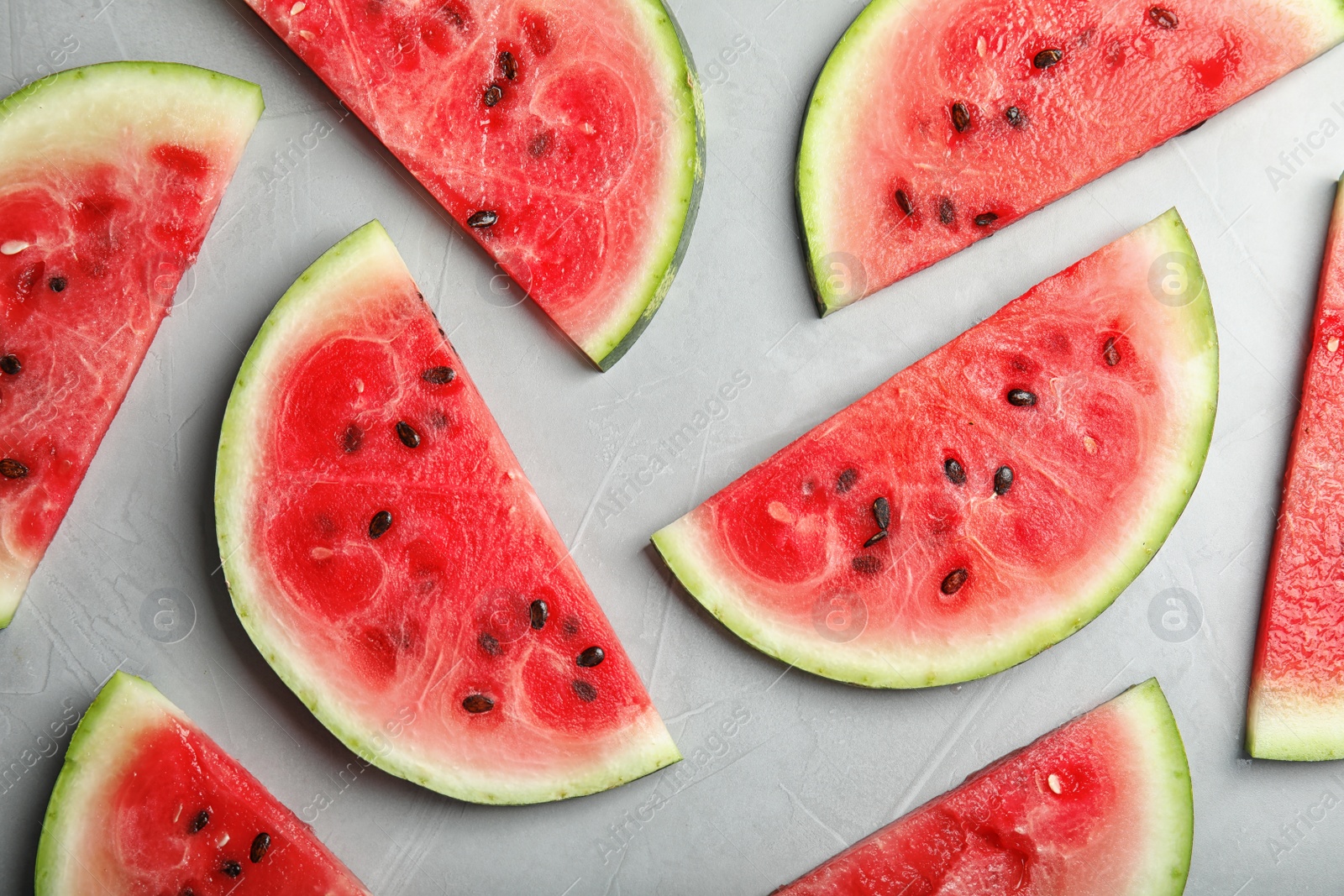 Photo of Flat lay composition with watermelon slices on grey background