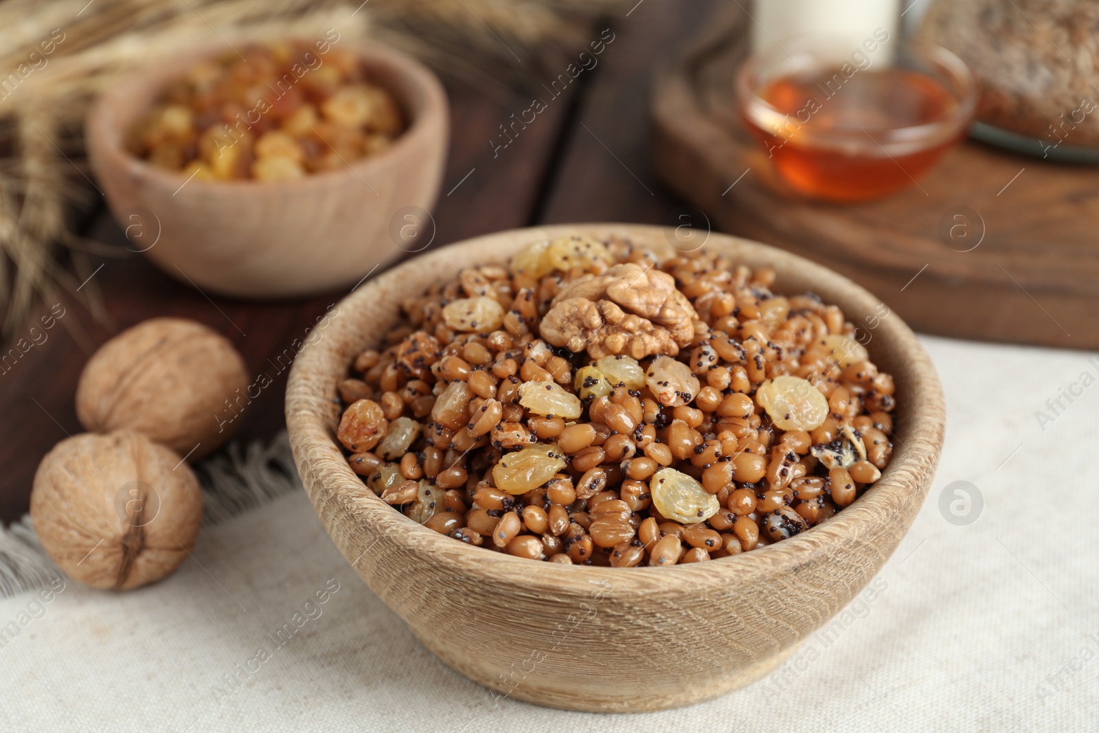 Photo of Traditional Christmas slavic dish kutia in bowl on napkin, closeup