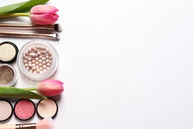 Photo of Different makeup products and flowers on white background, top view
