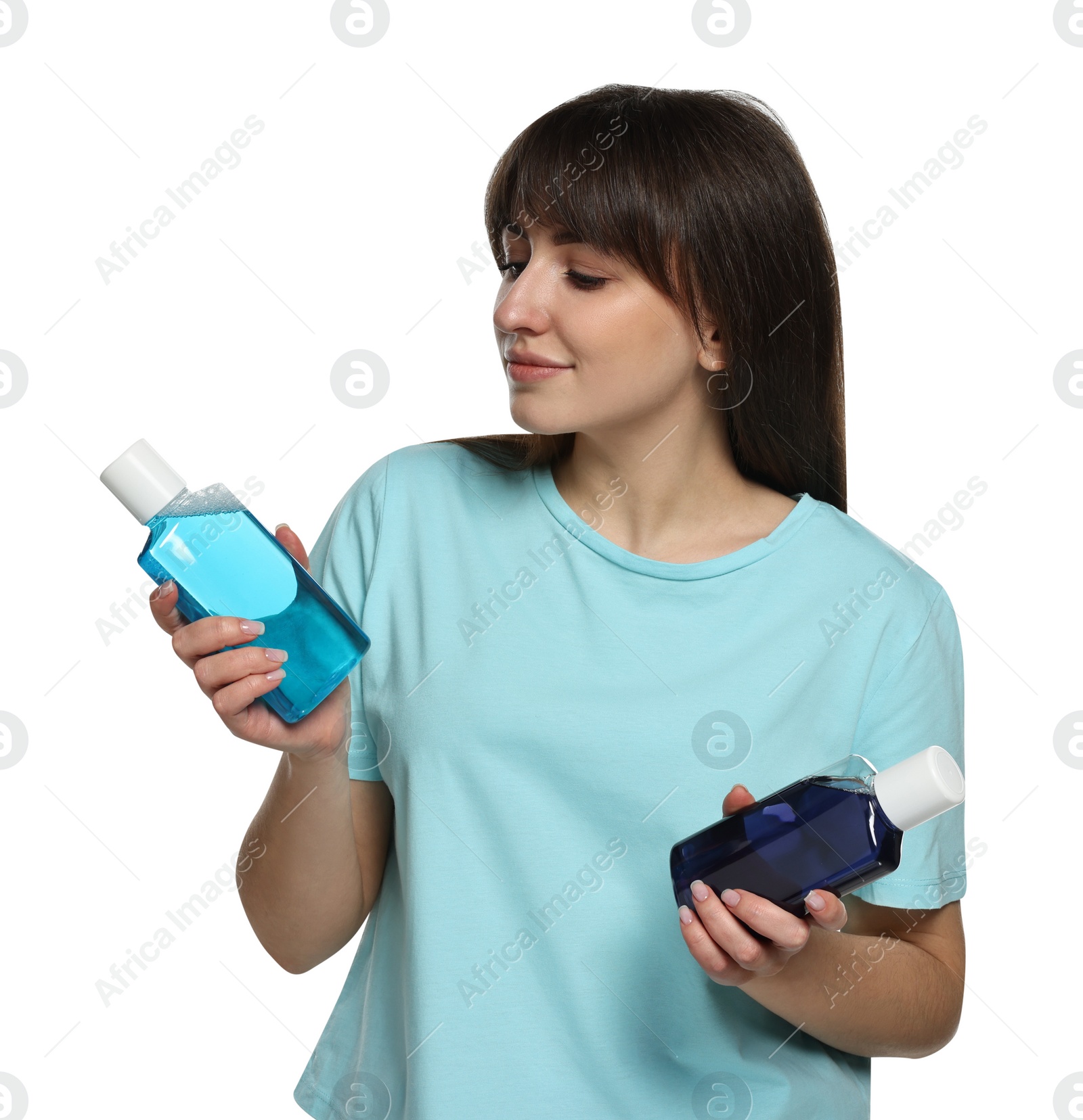 Photo of Young woman with different types of mouthwash on white background