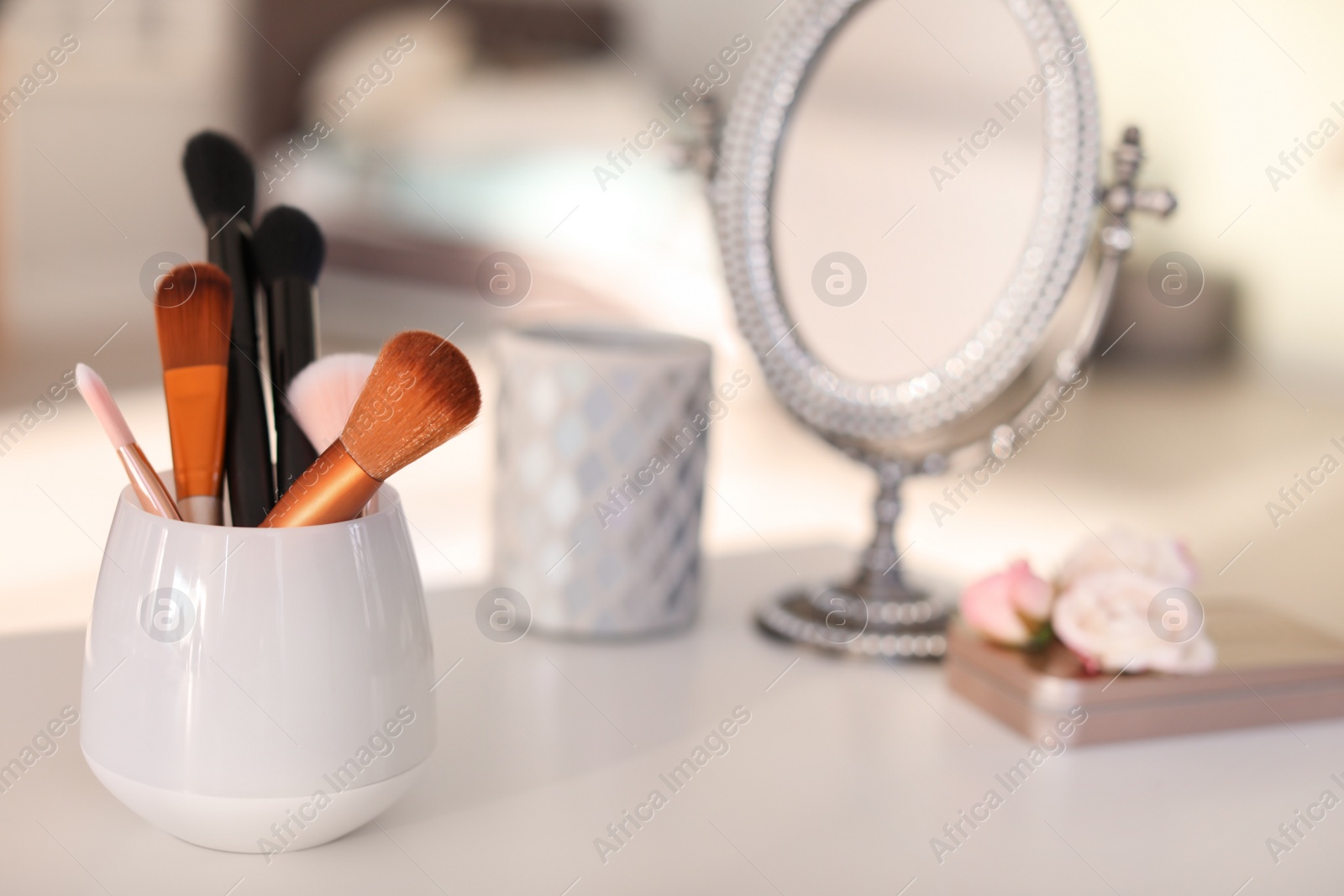 Photo of Holder with makeup brushes on table