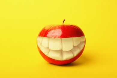 Photo of Funny smiling apple on color background