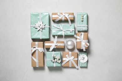 Flat lay composition of color Christmas gift boxes on light background