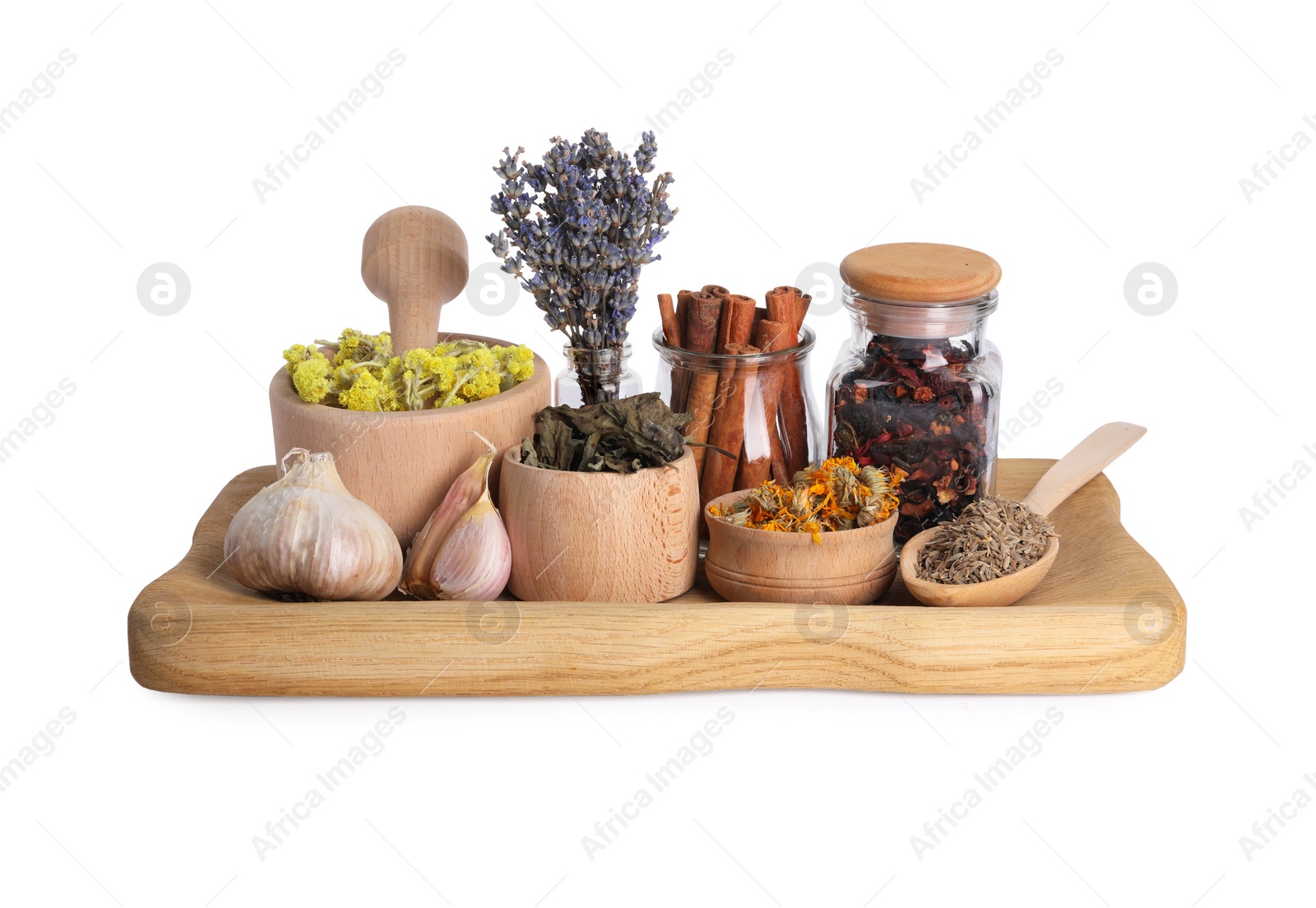 Photo of Mortar with pestle, many different dry herbs and spices isolated on white