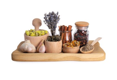 Photo of Mortar with pestle, many different dry herbs and spices isolated on white