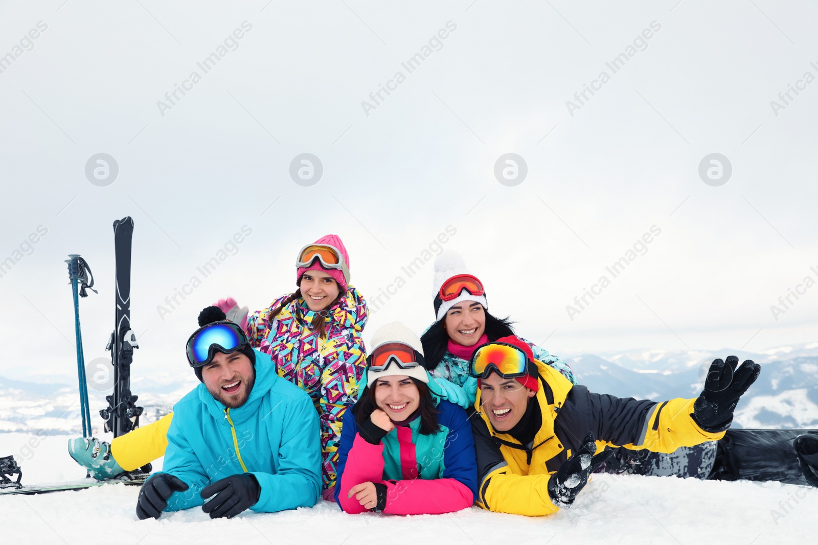 Photo of Group of friends with equipment in snowy mountains. Winter vacation