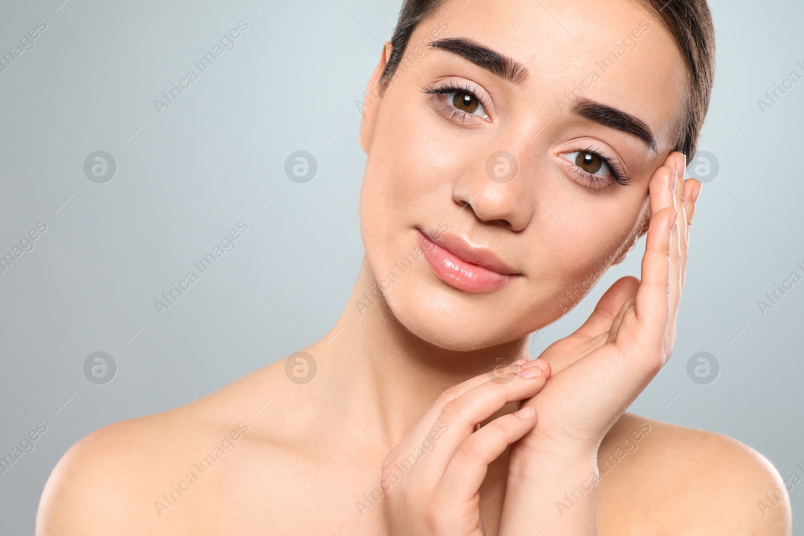 Photo of Portrait of young woman with beautiful face against color background