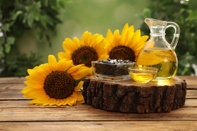 Photo of Composition with sunflower oil on wooden table against blurred background