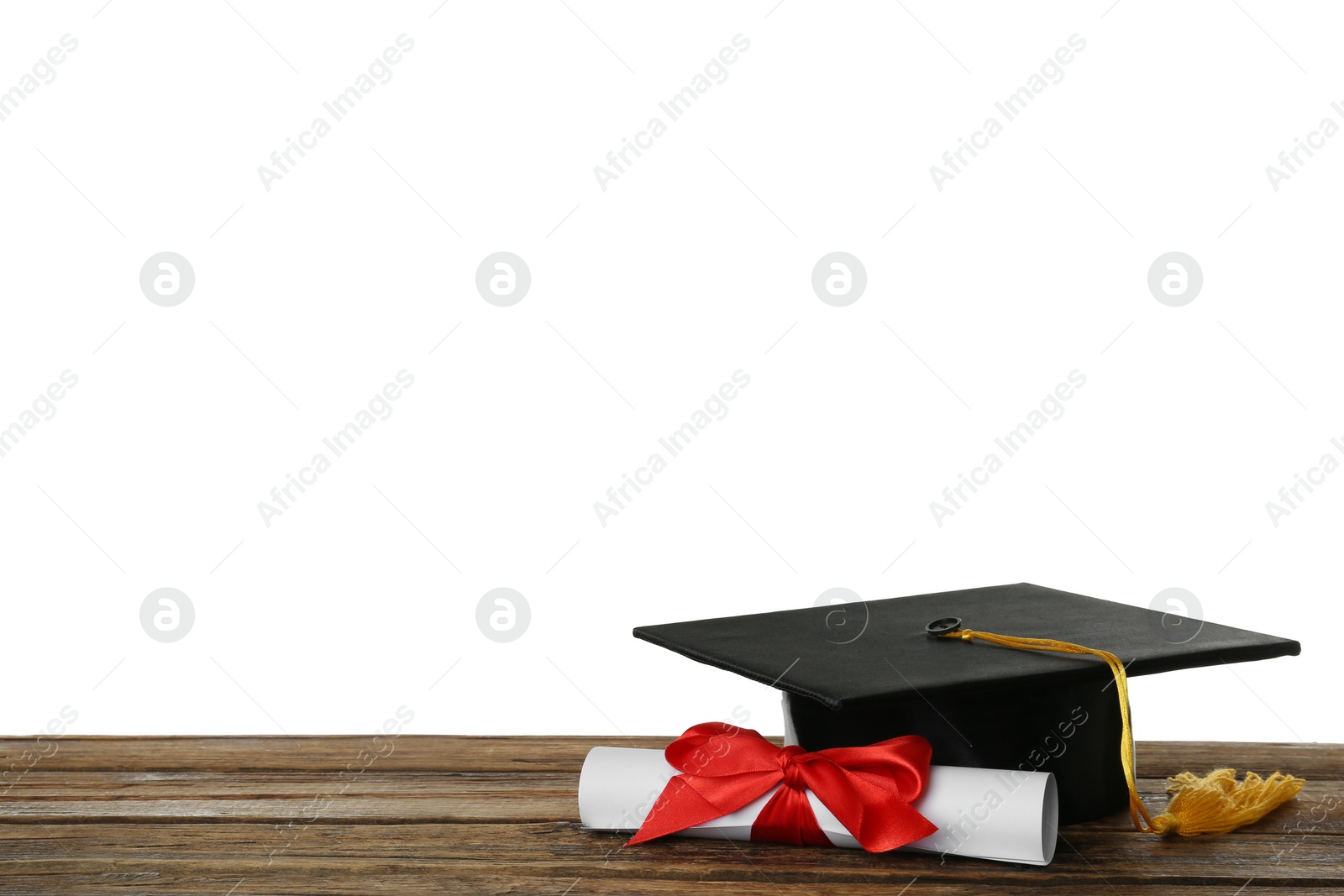 Photo of Graduation hat and diploma on wooden table against  white background, space for text