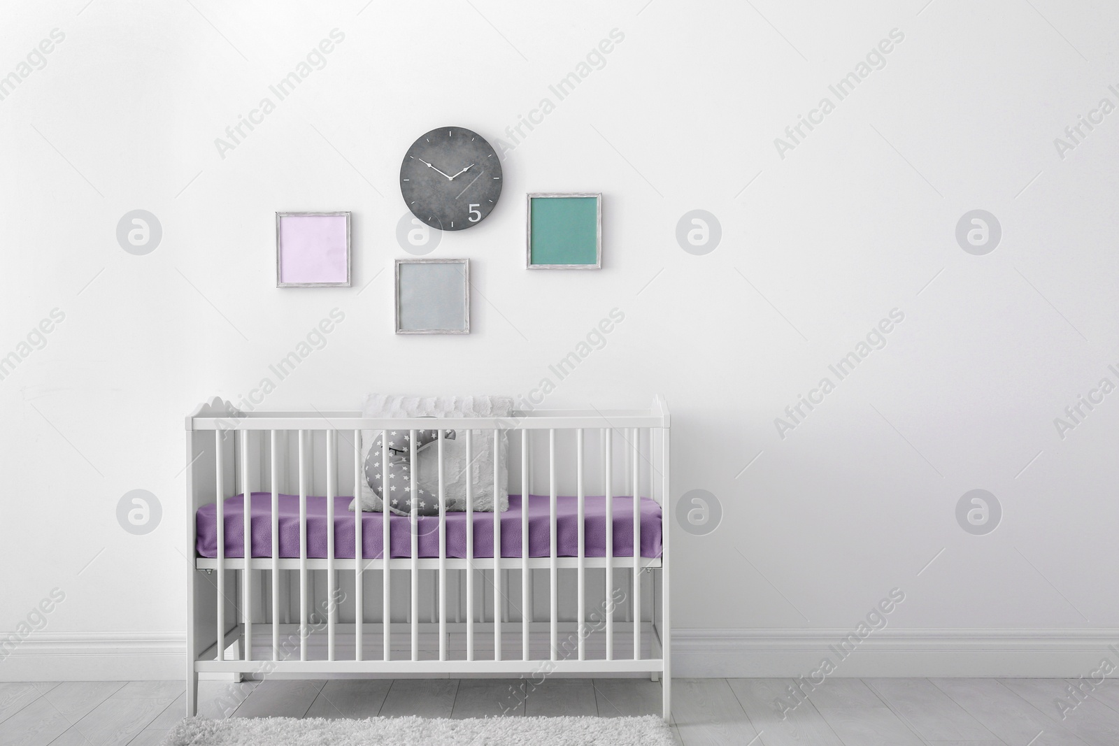 Photo of Baby room interior with crib near wall