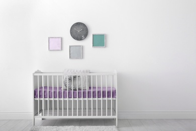 Baby room interior with crib near wall