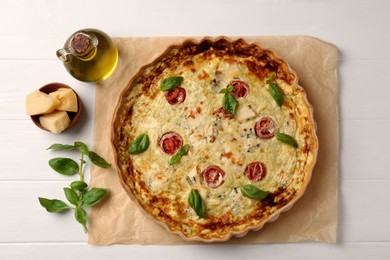 Photo of Delicious homemade cheese quiche and ingredients on white table, flat lay