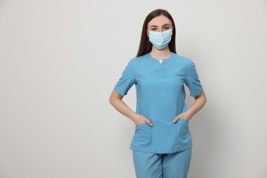 Photo of Nurse with medical mask on white background, space for text