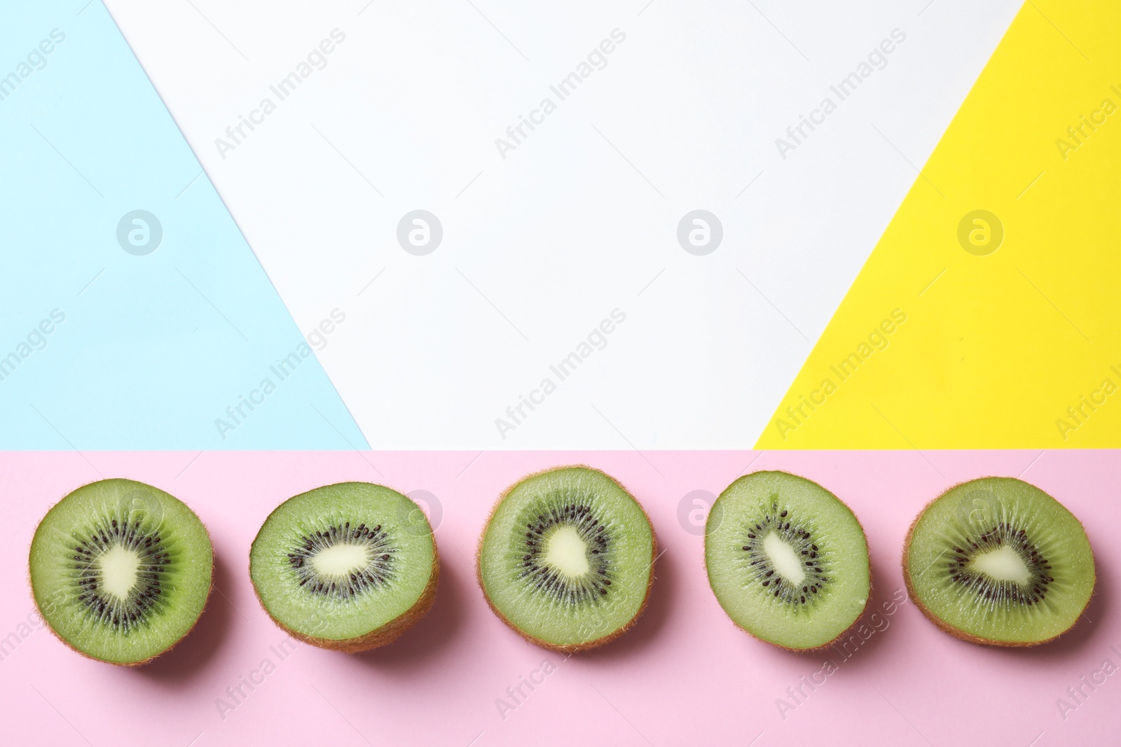 Photo of Top view of sliced fresh kiwis on color background. Space for text