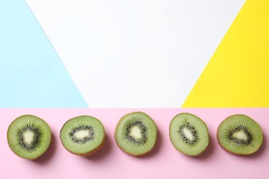 Photo of Top view of sliced fresh kiwis on color background. Space for text