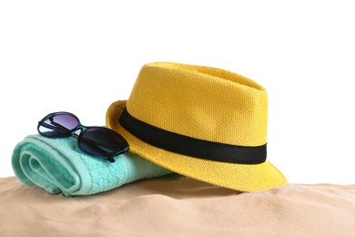 Composition with hat, beach sand and sunglasses on white background