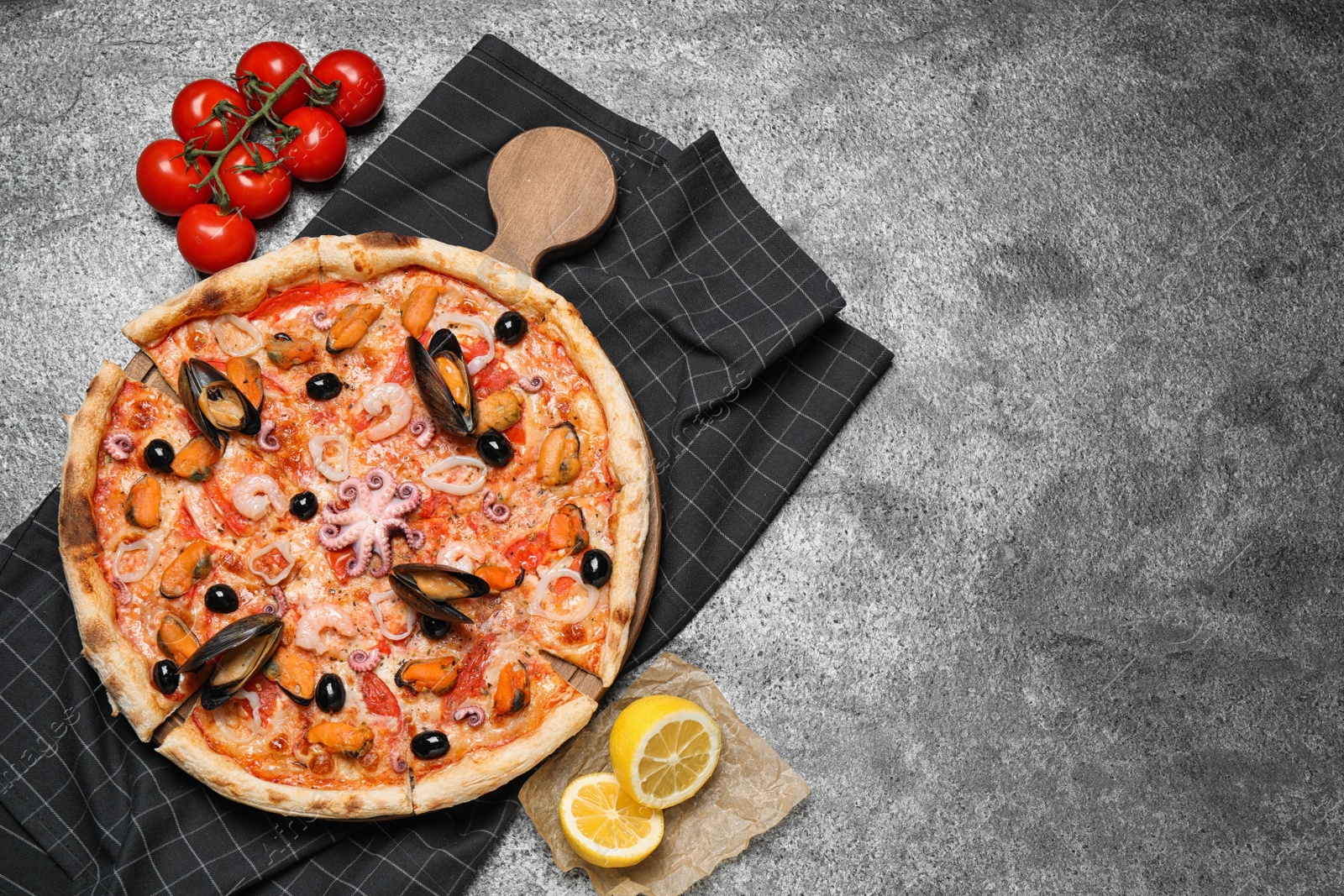 Photo of Tasty pizza with seafood and ingredients on grey table, flat lay. Space for text