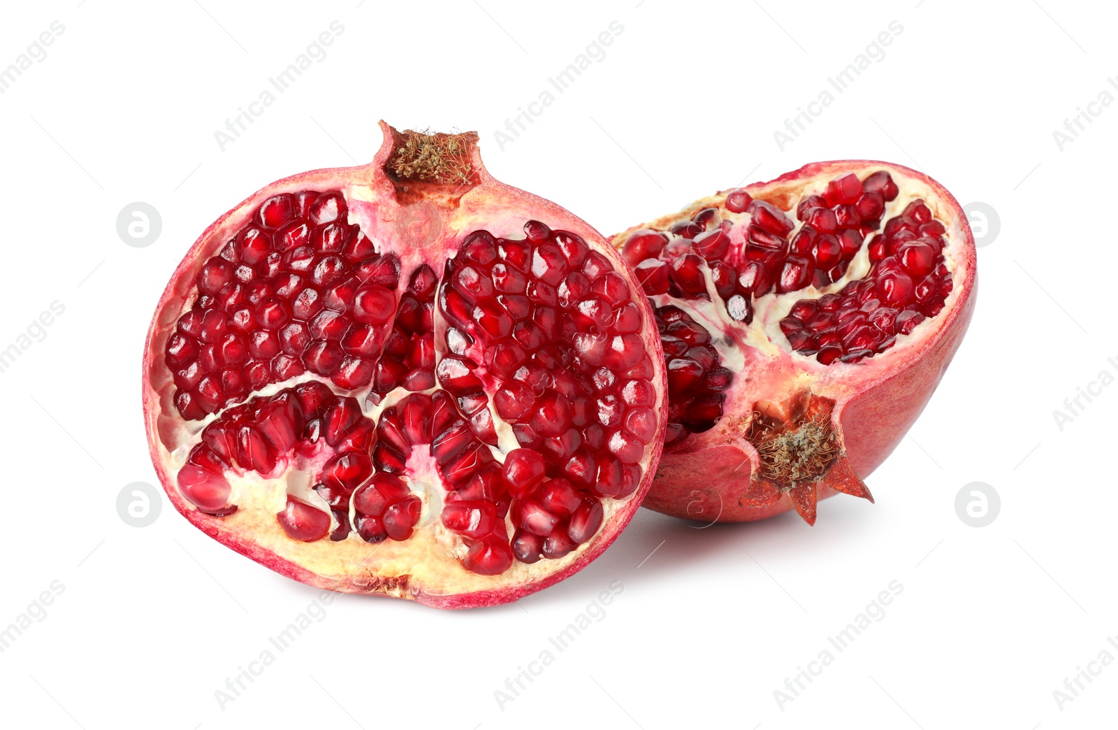 Photo of Halves of fresh pomegranate isolated on white