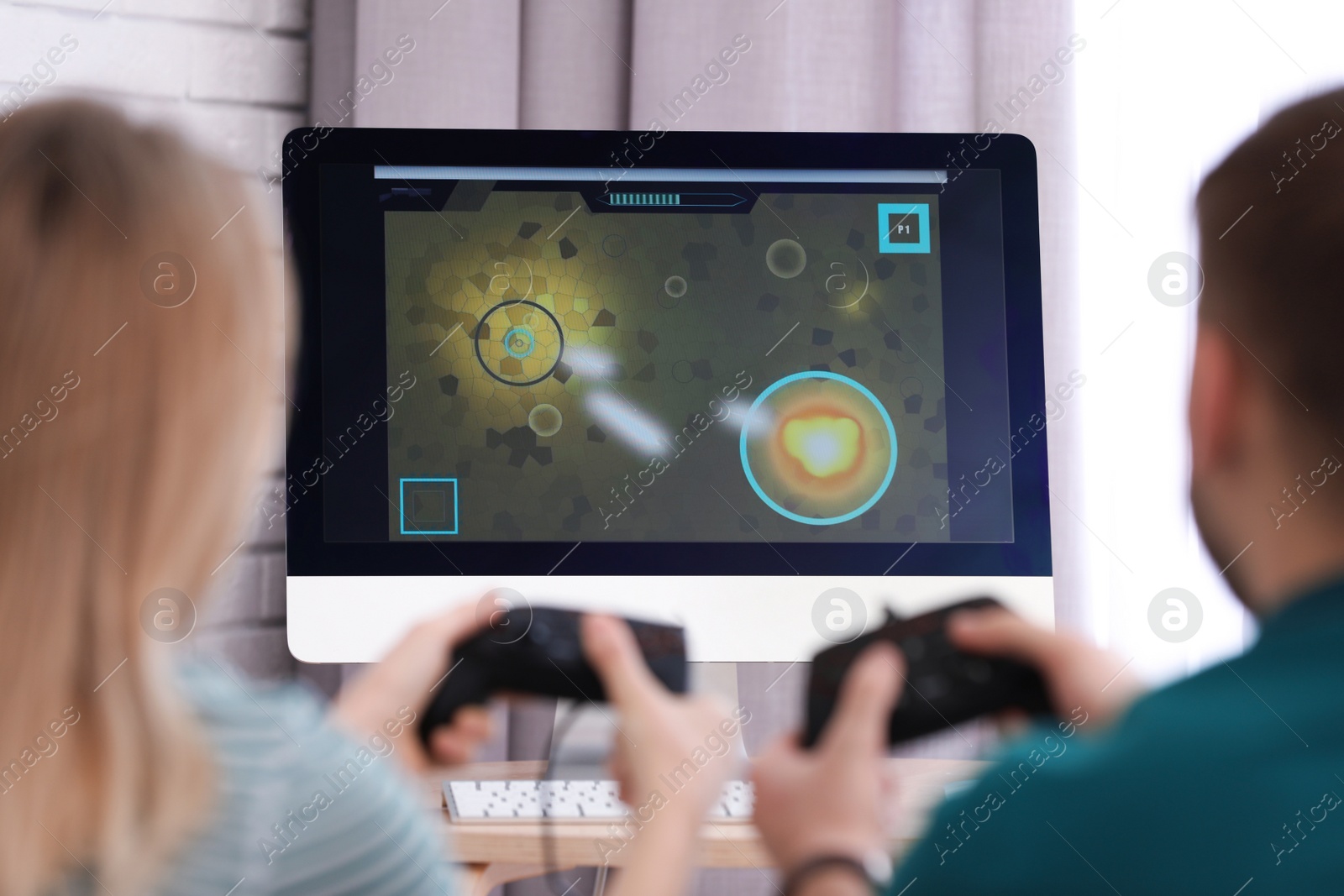 Photo of Young couple playing video game at home