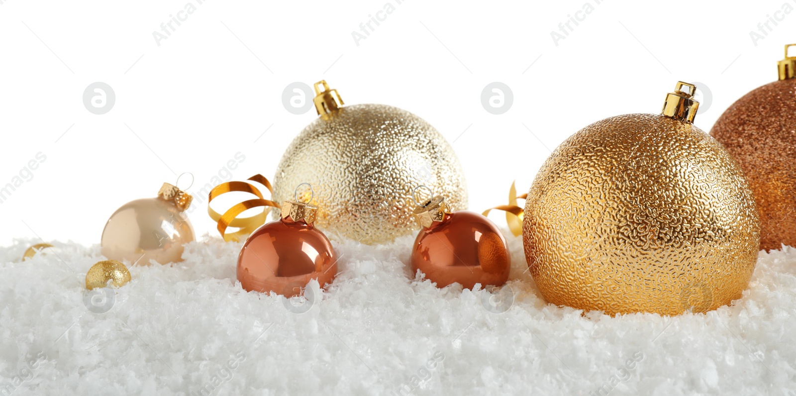 Photo of Christmas tree decoration on artificial snow against white background