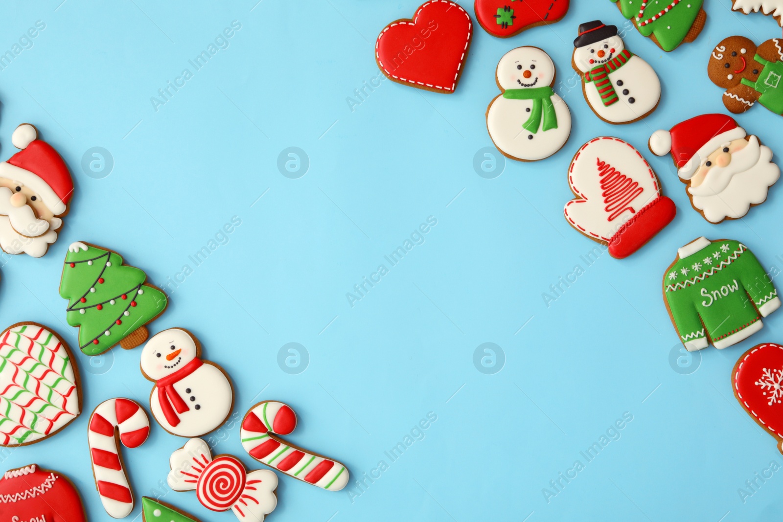 Photo of Different Christmas gingerbread cookies on light blue background, flat lay. Space for text