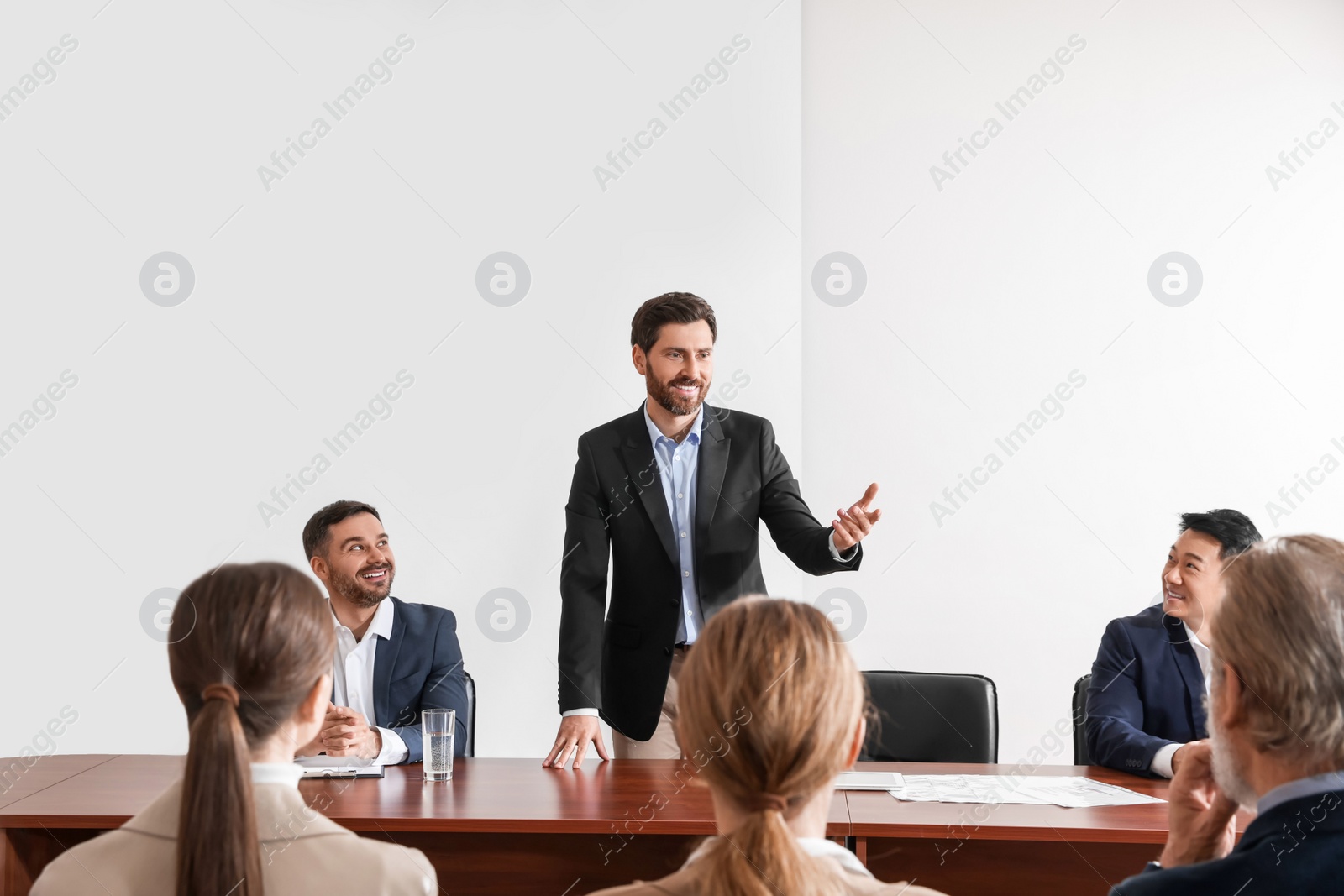 Photo of Business conference. People in meeting room listening to speaker report