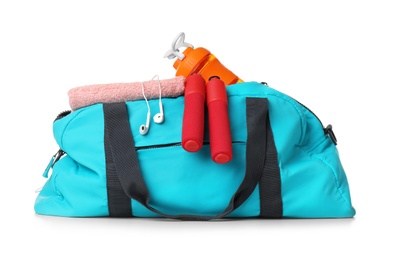 Sports bag with gym equipment on white background