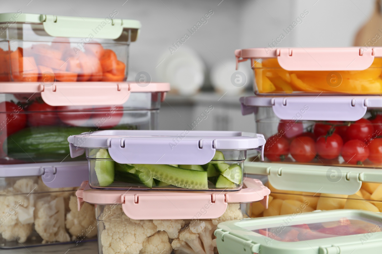 Photo of Boxes with fresh raw vegetables on table in kitchen