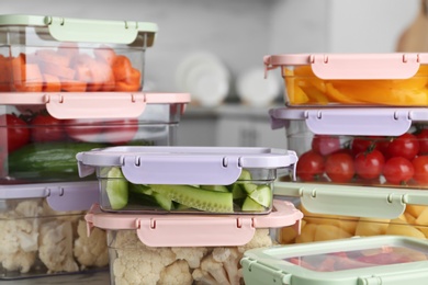 Photo of Boxes with fresh raw vegetables on table in kitchen