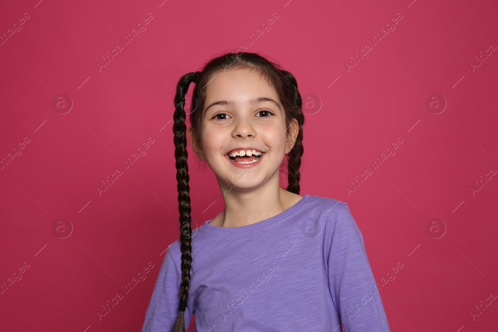 Photo of Portrait of little girl laughing on color background