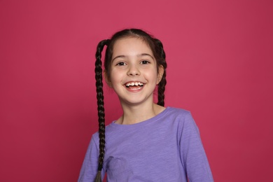 Photo of Portrait of little girl laughing on color background