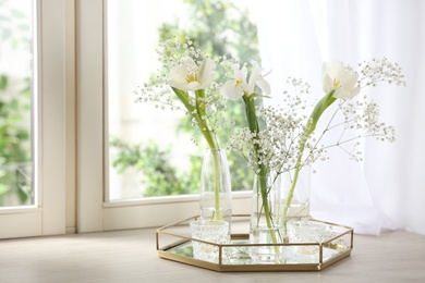 Beautiful fresh flowers on window sill indoors