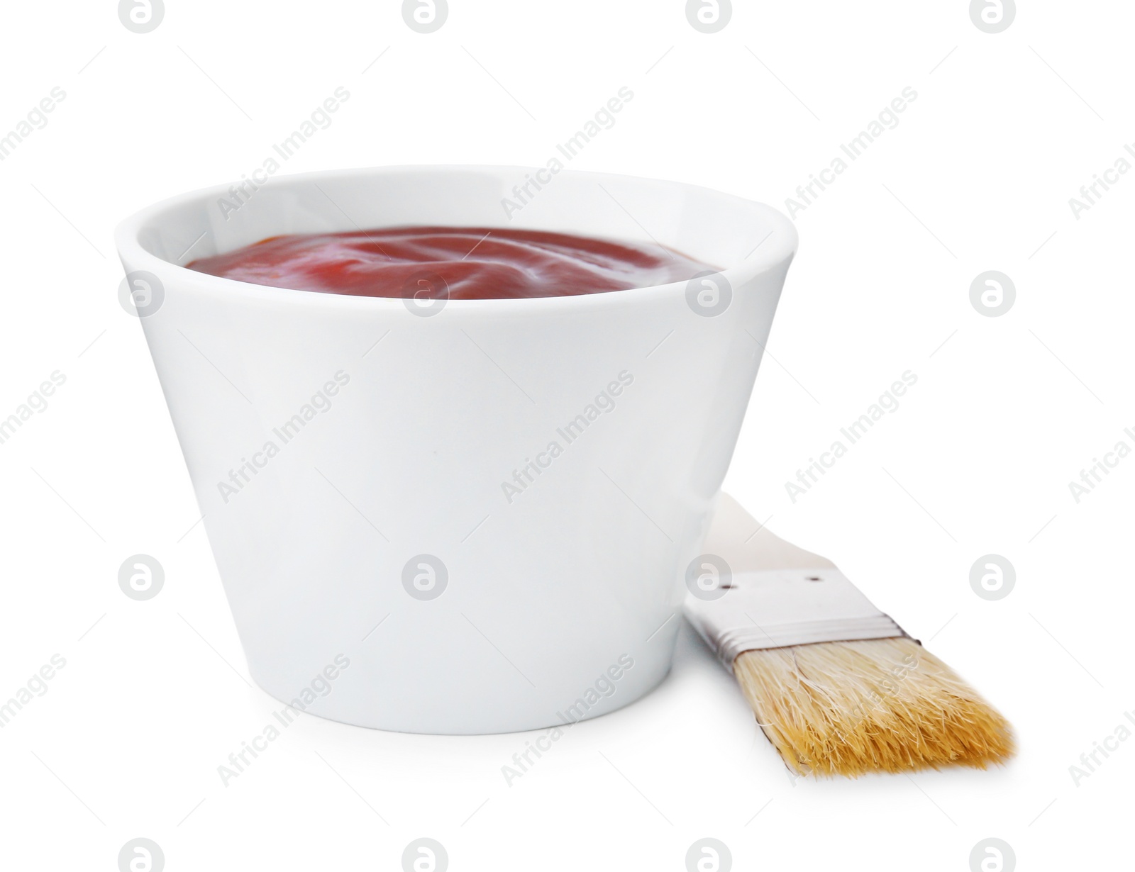 Photo of Marinade in bowl and basting brush isolated on white