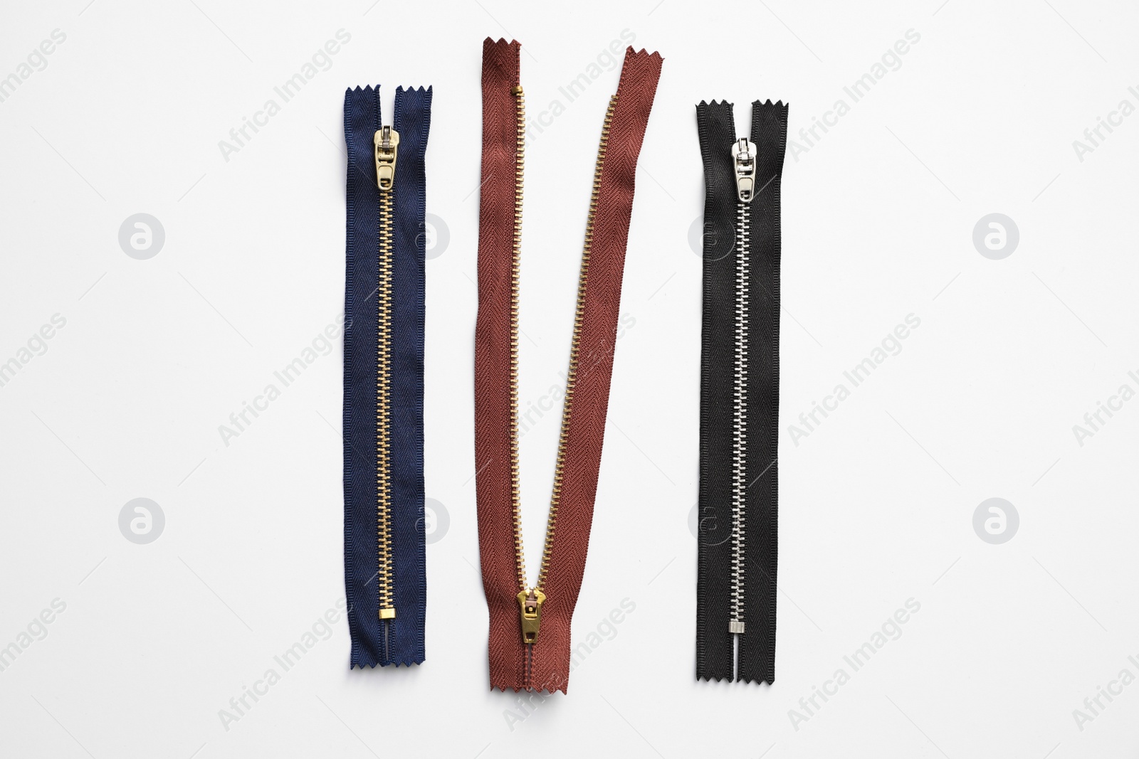 Photo of Jeans zippers isolated on white, top view