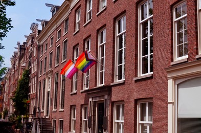 Photo of Rainbow and lesbian flags on building outdoors