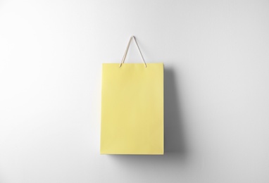 Photo of Paper shopping bag hanging on white wall