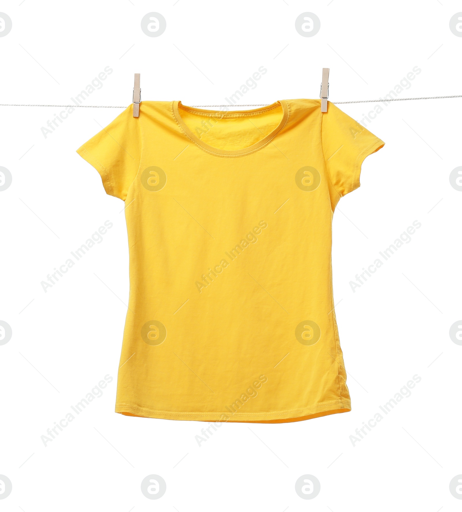 Photo of Yellow t-shirt drying on washing line against white background