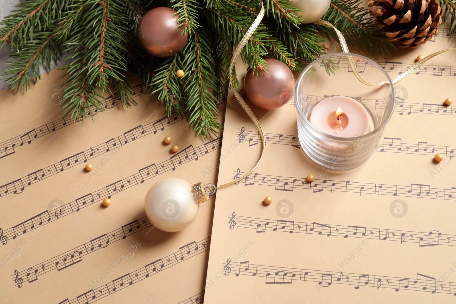 Photo of Composition with Christmas decorations on music sheets, above view