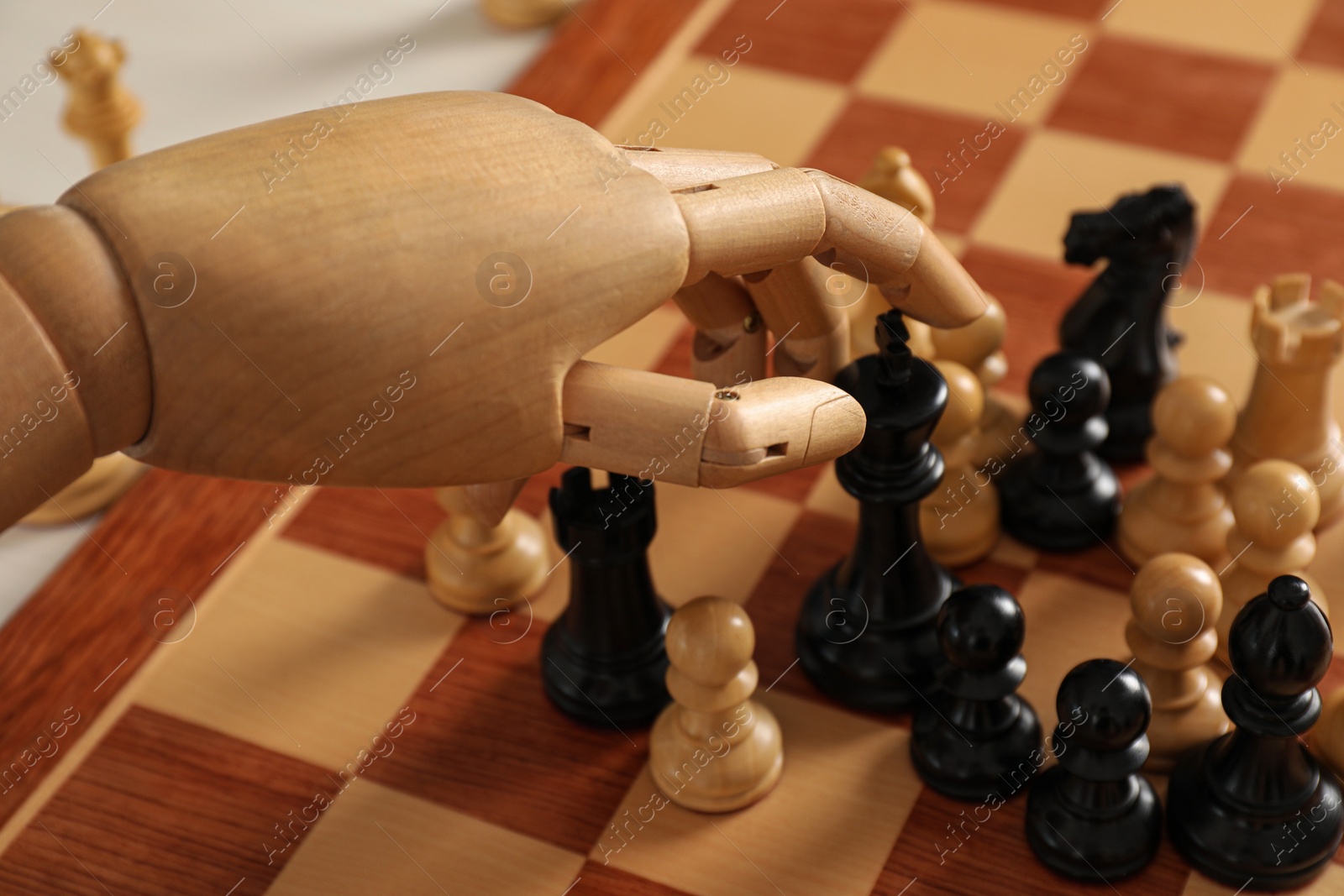 Photo of Robot moving chess piece on board, closeup. Wooden hand representing artificial intelligence