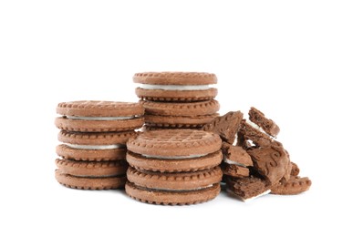 Photo of Tasty chocolate sandwich cookies with cream on white background