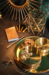 Photo of Composition with stylish accessories and interior elements on grey table