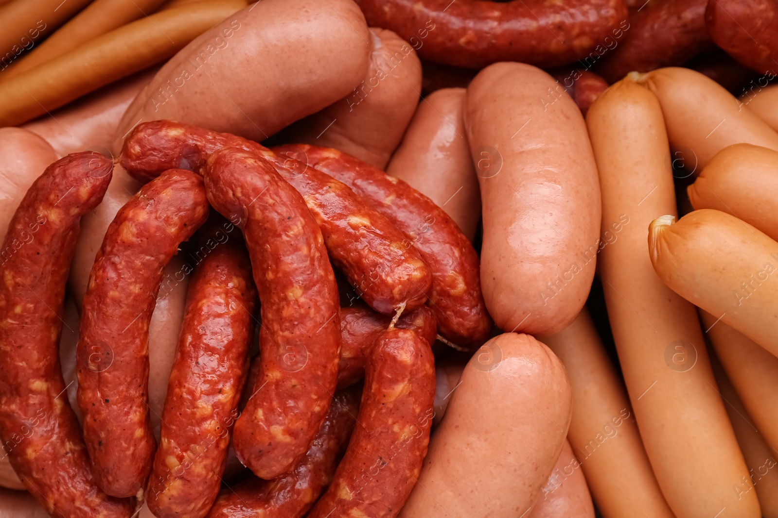 Photo of Different tasty sausages as background, closeup view