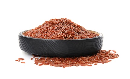 Plate with uncooked red rice on white background