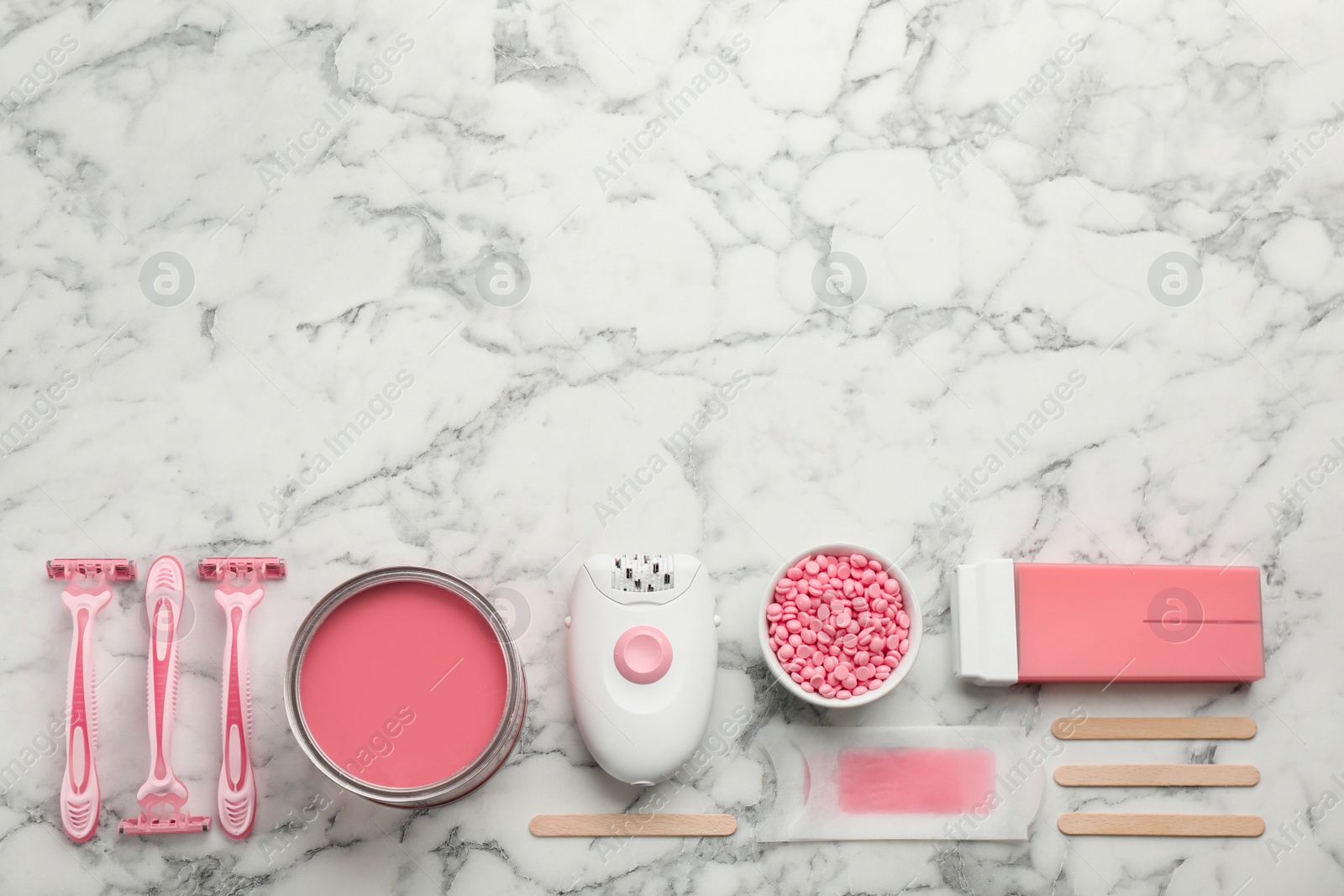 Photo of Set of epilation products on white marble table, flat lay. Space for text