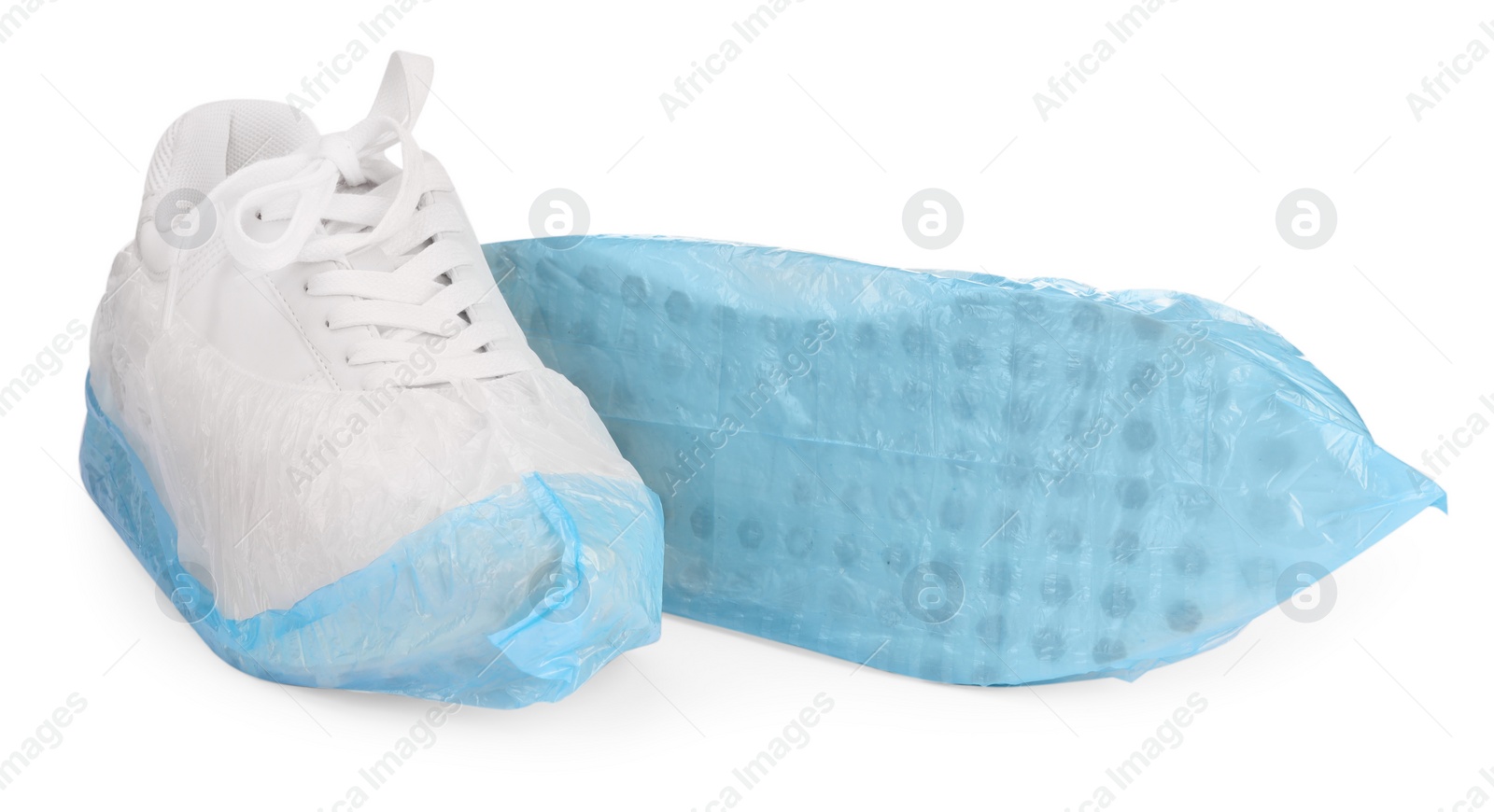 Photo of Sneakers in shoe covers isolated on white