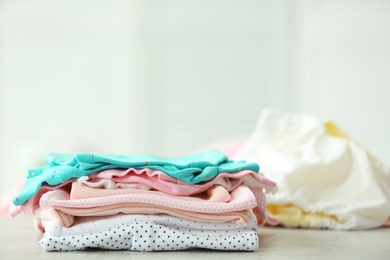 Photo of Pile of baby clothes on table