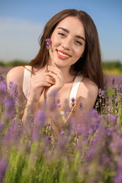 Photo of Young woman in lavender field on summer day