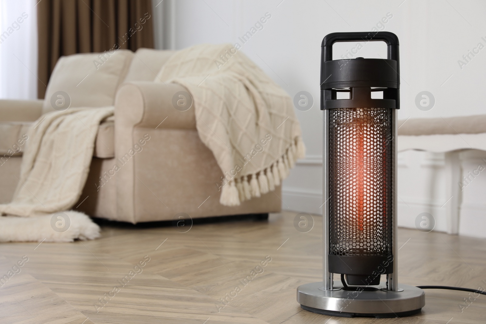 Photo of Modern electric heater on floor at home. Space for text