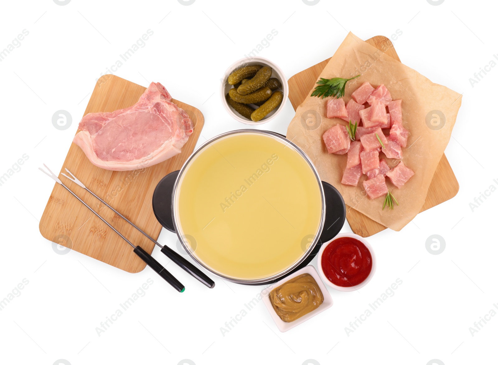 Photo of Oil in fondue pot, forks, pickles, sauces and pieces of raw meat isolated on white, top view