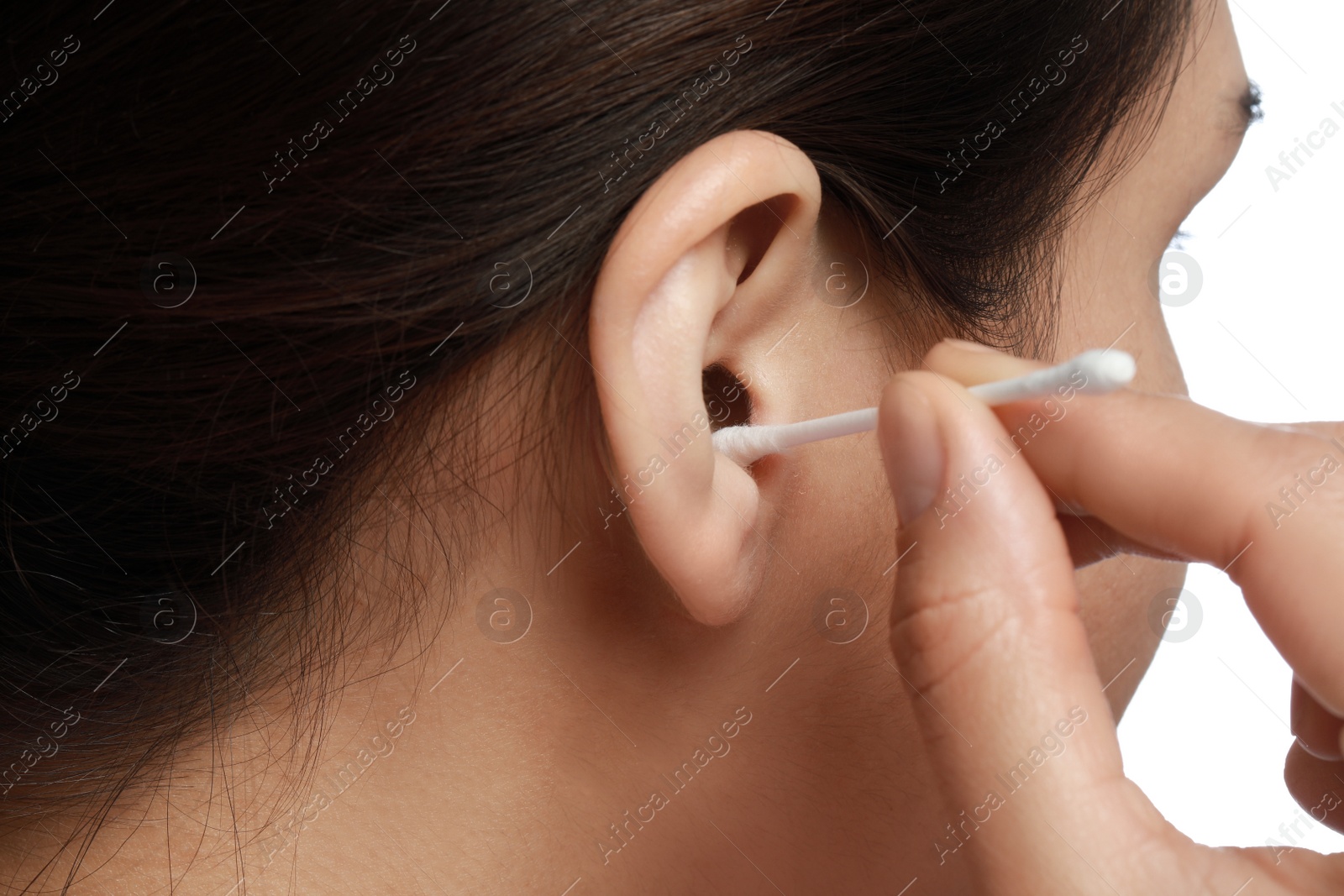 Photo of Woman cleaning ear with cotton swab on white background, closeup